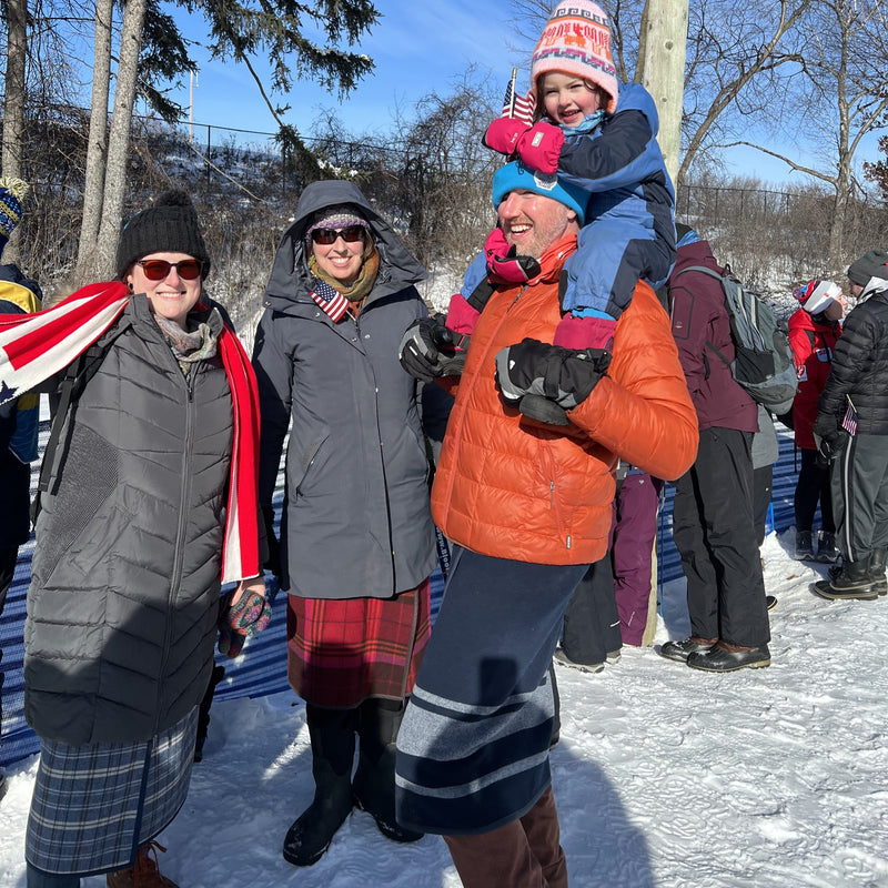 Adults wearing NorSari wraps with winter clothing at an outdoor winter event